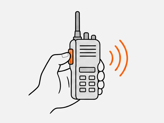 A thumb pressing the push-to-talk button on the side of a radio