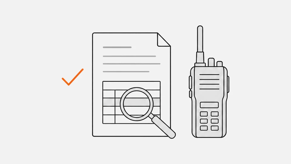 A spec sheet under a magnifying glass next to a radio