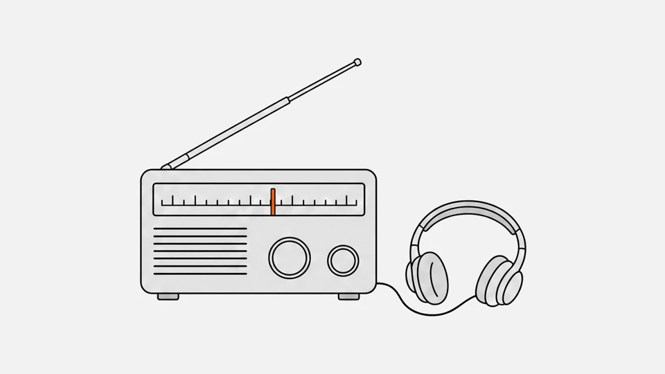 A desktop shortwave receiver with a tuning dial, a telescopic antenna and headphones